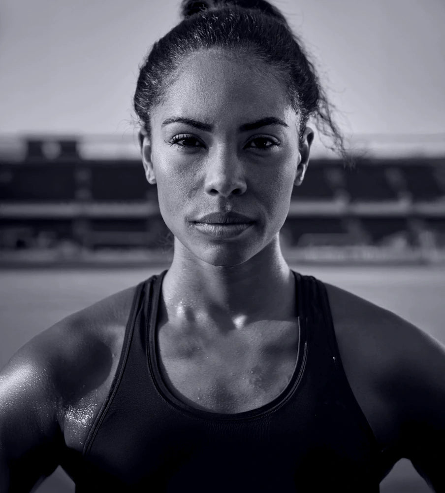 Black and white photo of a woman in athletic wear outdoors