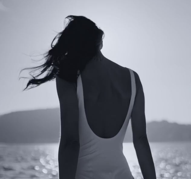 Backview of woman walking on the beach