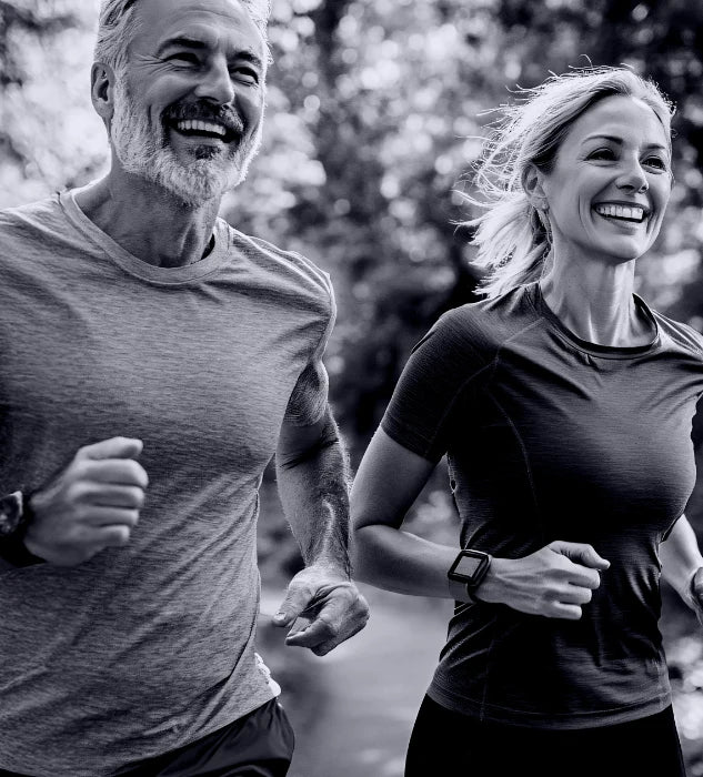 Two people jogging outdoors with a blurred natural background